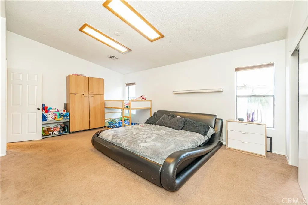 9080 Bloomfield Avenue, Unit 191 Cypress, CA 90630 - Photo 8 of 22 a bedroom with a bed and a window