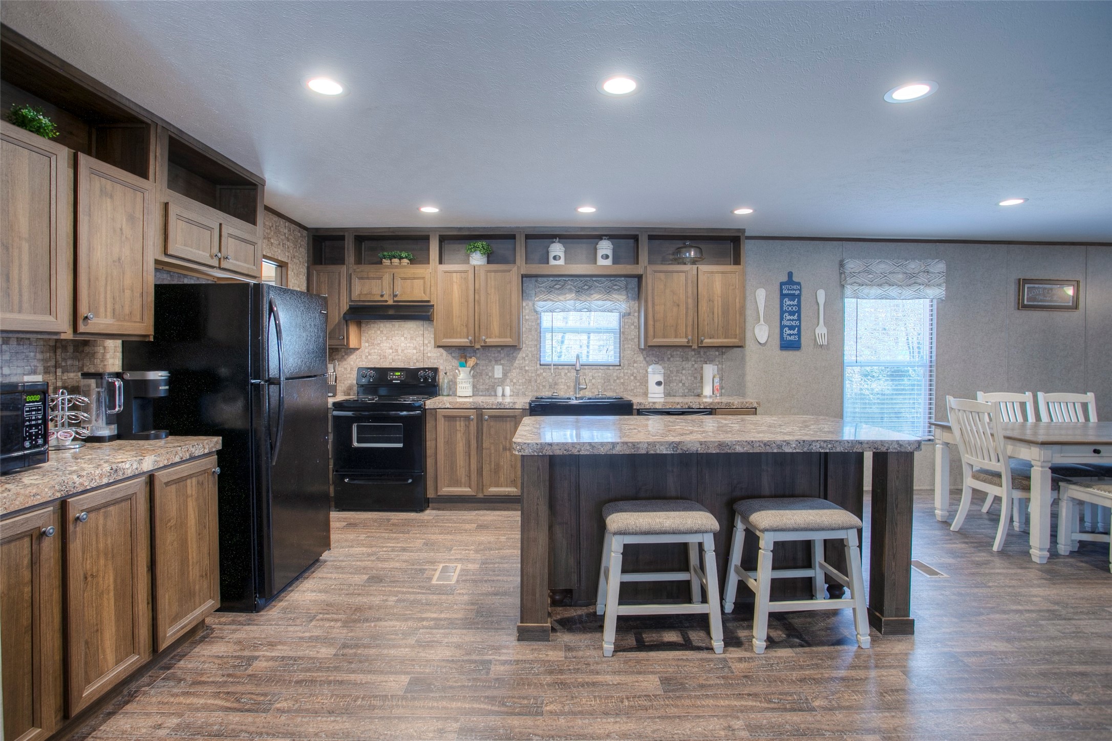 a kitchen with granite countertop kitchen island wooden cabinets and stainless steel appliances