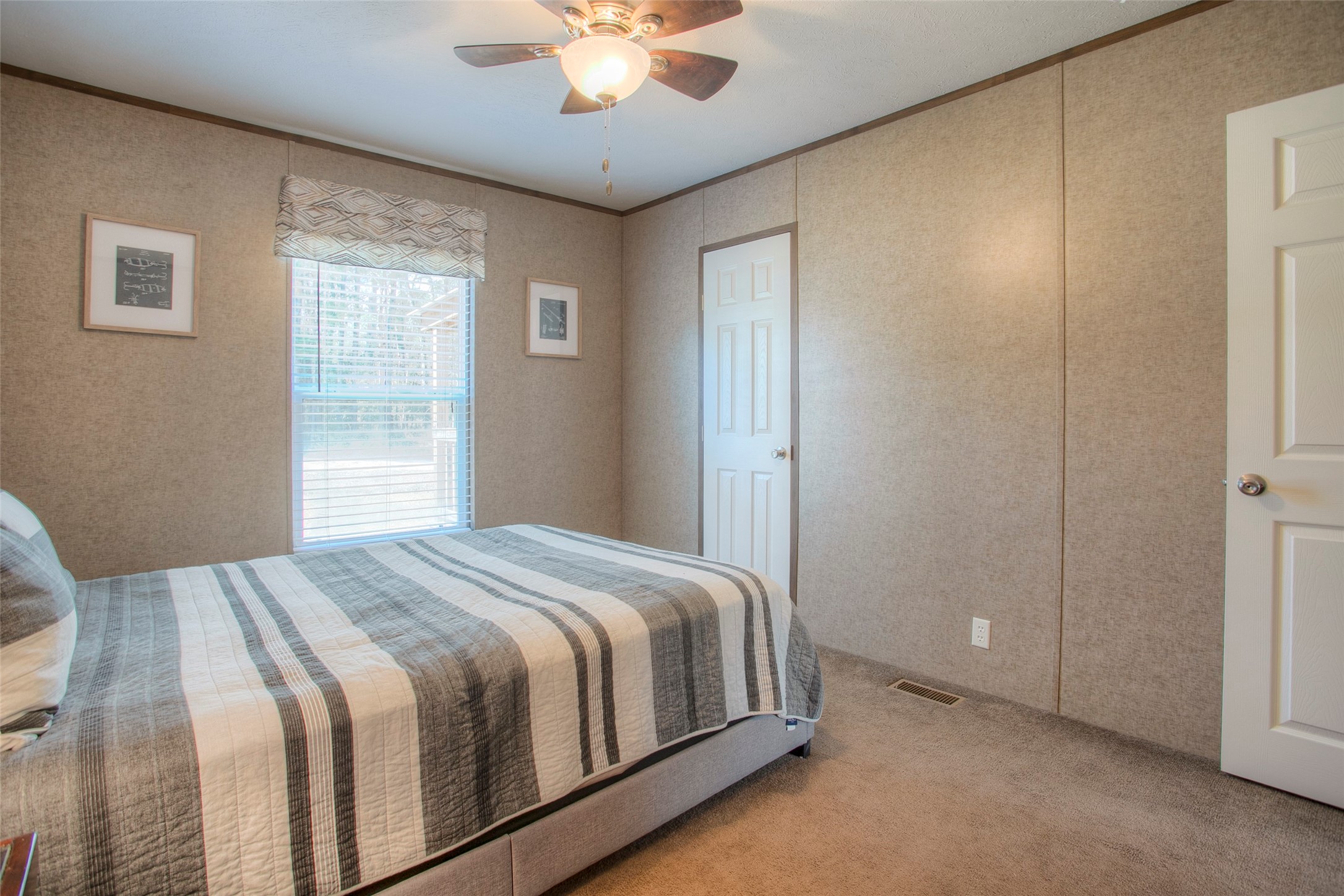 277 Rio Grande Drive Trinity, TX 75862 - Photo 21 of 50 a bedroom with a large bed and a chandelier