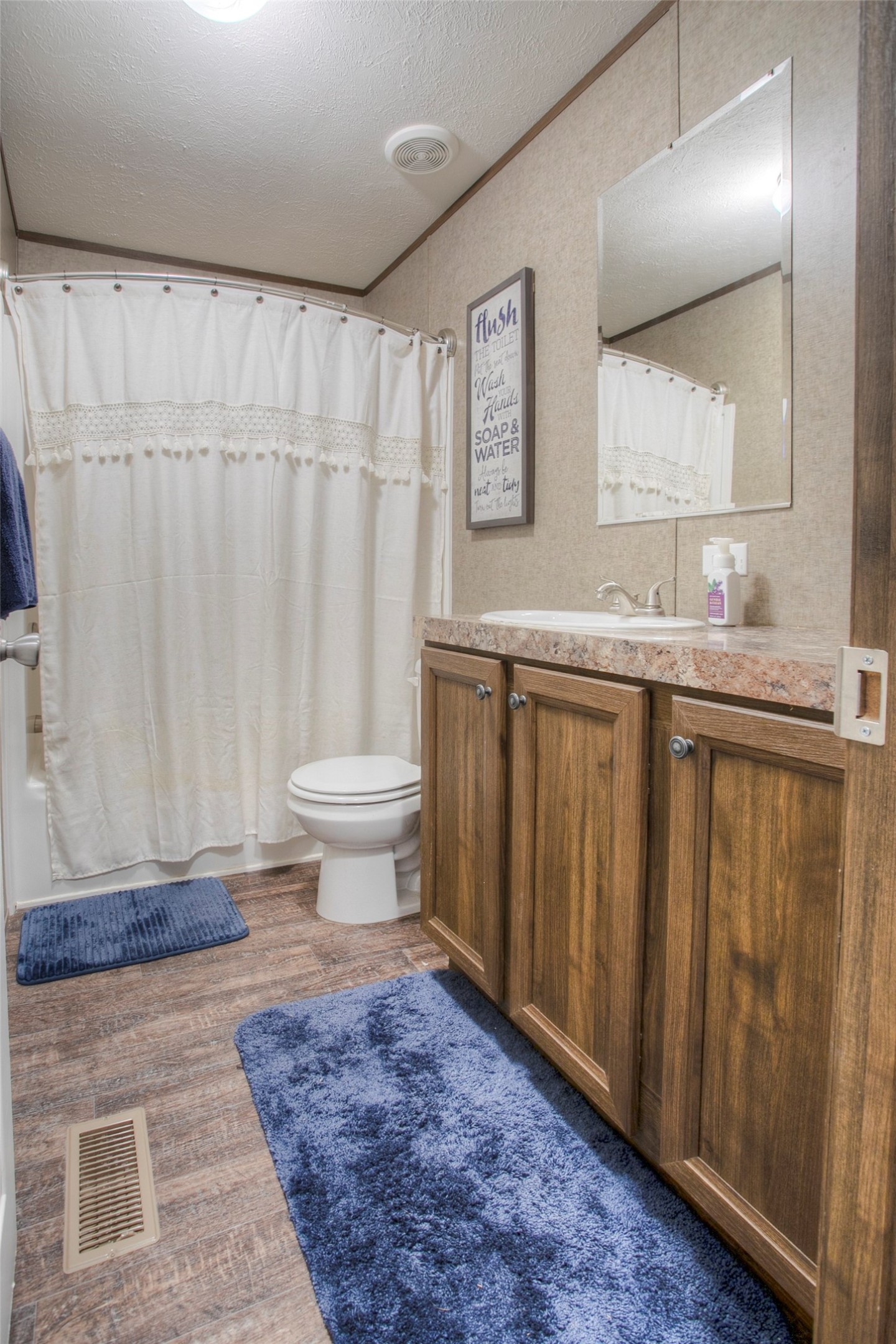 277 Rio Grande Drive Trinity, TX 75862 - Photo 24 of 50 a bathroom with a granite countertop sink and a toilet