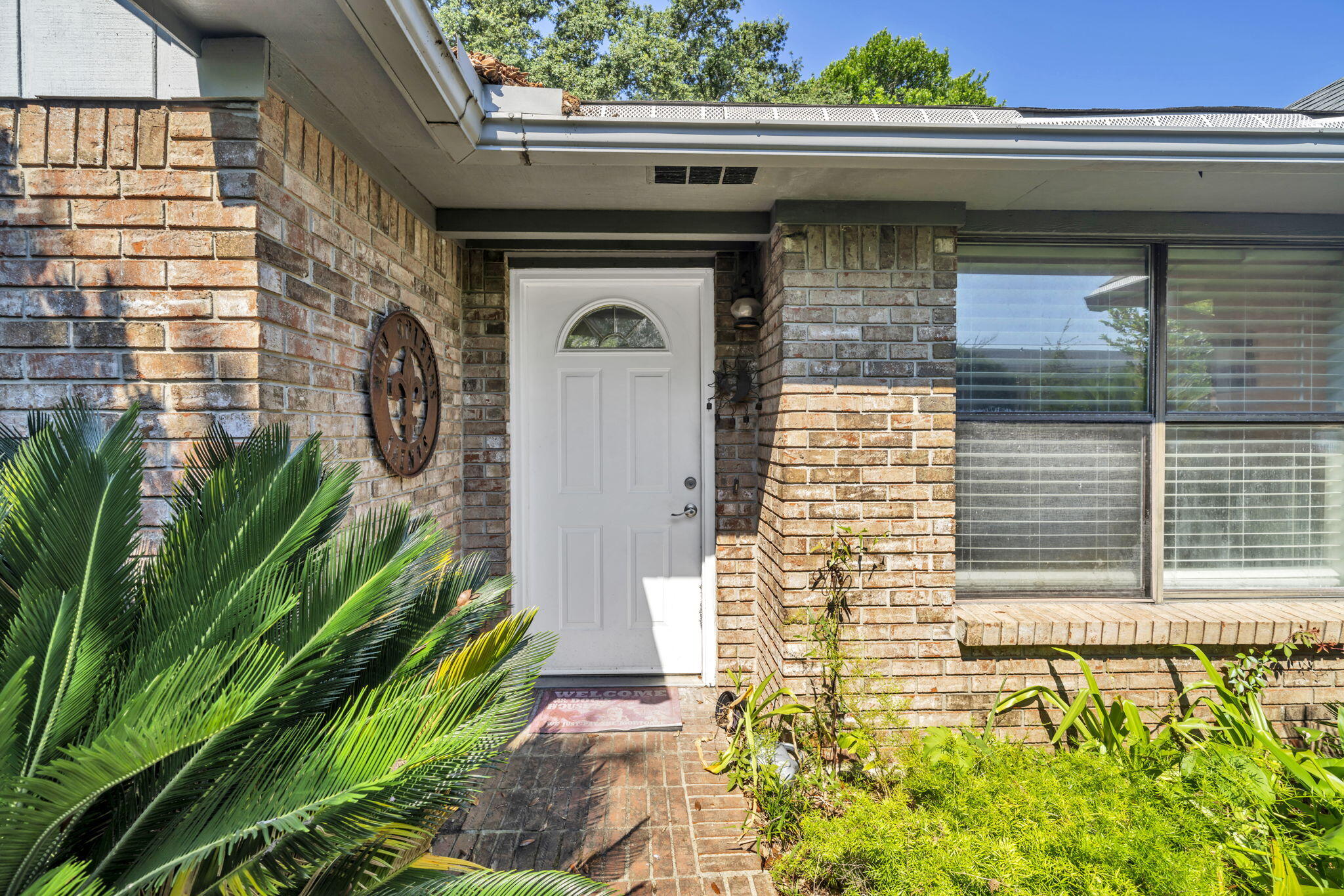 a front view of a house with a garden