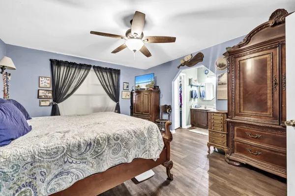 a bedroom with a bed and a chandelier