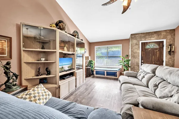 a living room with furniture and a floor to ceiling window
