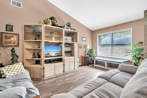 a living room with furniture cabinets and a window