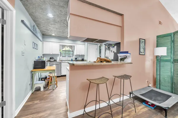 a kitchen with stainless steel appliances kitchen island granite countertop a sink and cabinets