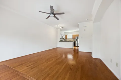 a kitchen with cabinets and wooden floor