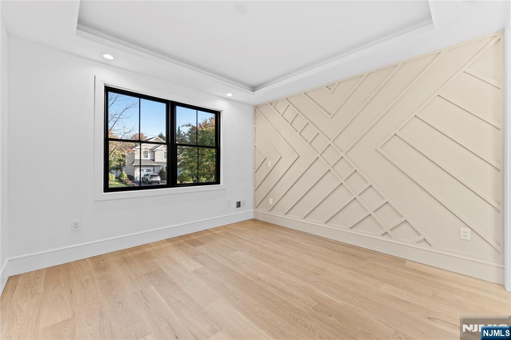 215 Kensington Road River Edge, NJ 07661 - Photo 13 of 37 an empty room with wooden floor and windows