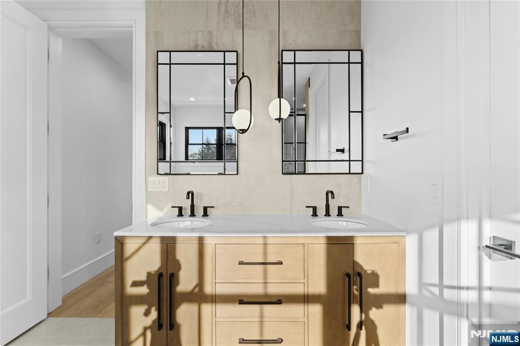 215 Kensington Road River Edge, NJ 07661 - Photo 22 of 37 a bathroom with two sink and a mirror