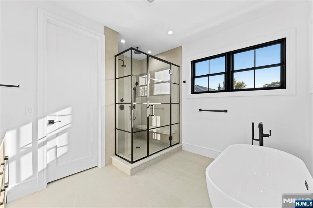 215 Kensington Road River Edge, NJ 07661 - Photo 23 of 37 a bathroom with a bathtub and a shower