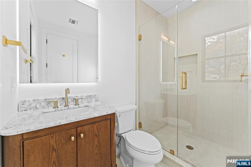 215 Kensington Road River Edge, NJ 07661 - Photo 26 of 37 a bathroom with a granite countertop sink toilet and shower