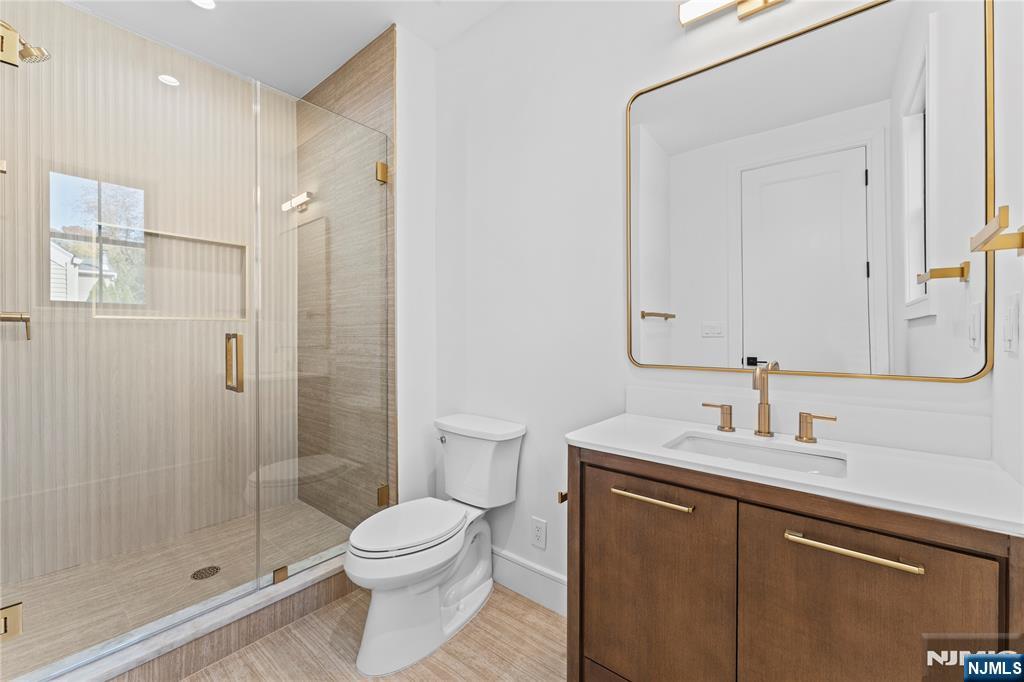 215 Kensington Road River Edge, NJ 07661 - Photo 31 of 37 a bathroom with a sink a toilet and shower