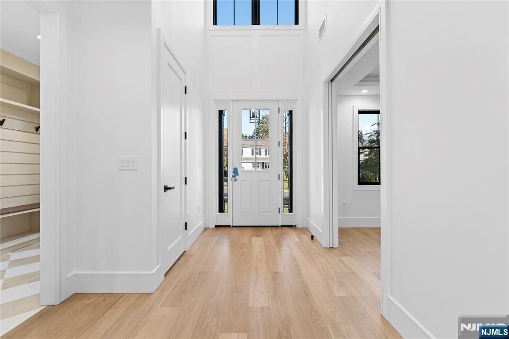 215 Kensington Road River Edge, NJ 07661 - Photo 4 of 37 an empty room with wooden floor and windows