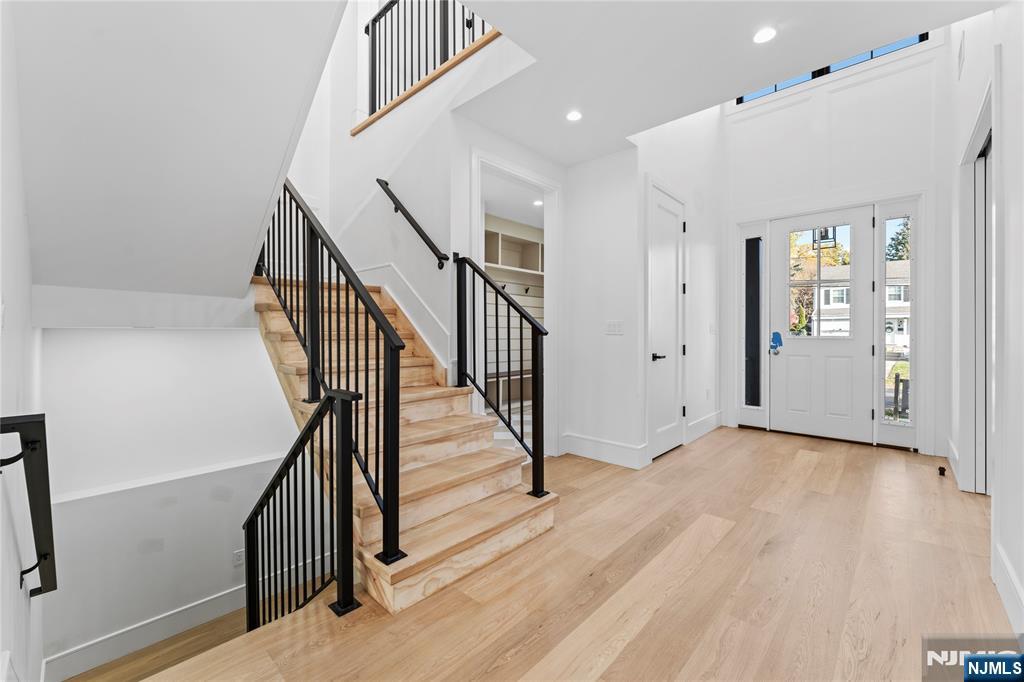 215 Kensington Road River Edge, NJ 07661 - Photo 5 of 37 a view of a hallway with wooden floor and stairs