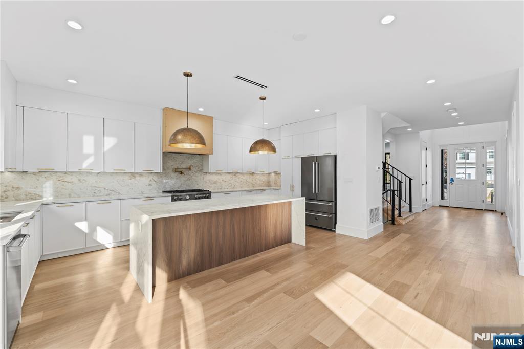 215 Kensington Road River Edge, NJ 07661 - Photo 7 of 37 a large kitchen with stainless steel appliances granite countertop a sink a stove and a refrigerator