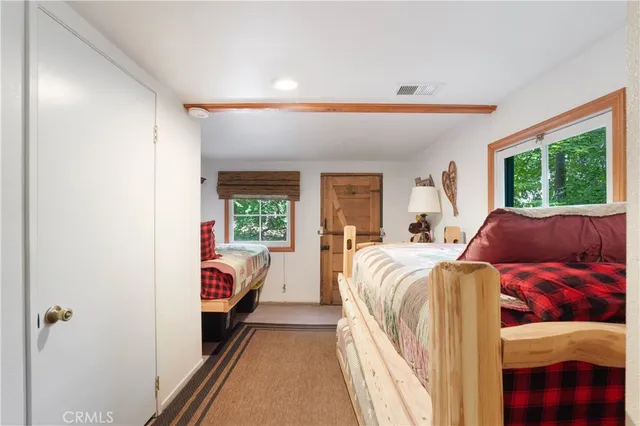 a bedroom with a bed and dresser