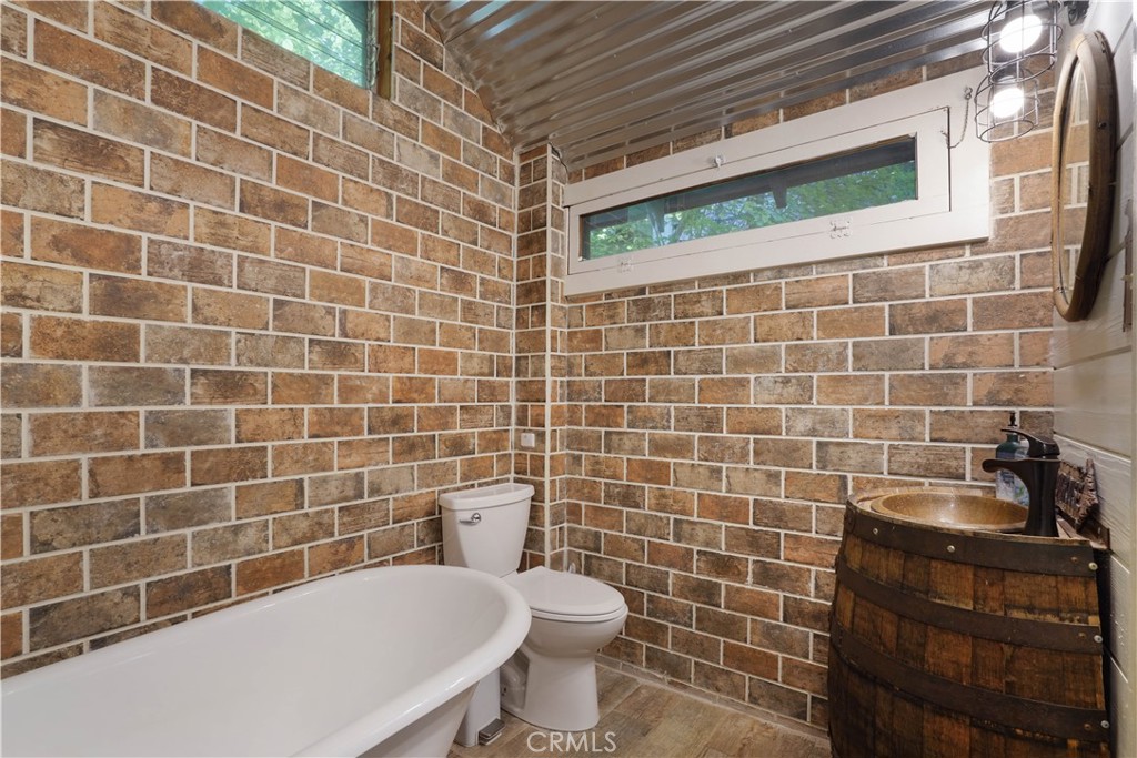 825 Cottage Grove Road Lake Arrowhead, CA 92352 - Photo 21 of 25 a bathroom with a toilet a sink and a mirror