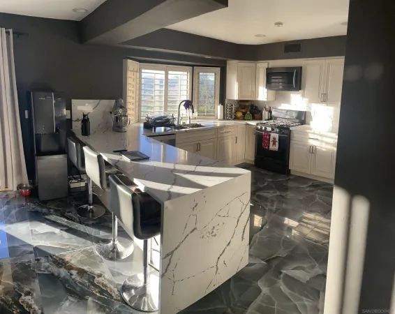 a living room with patio couch and a large window