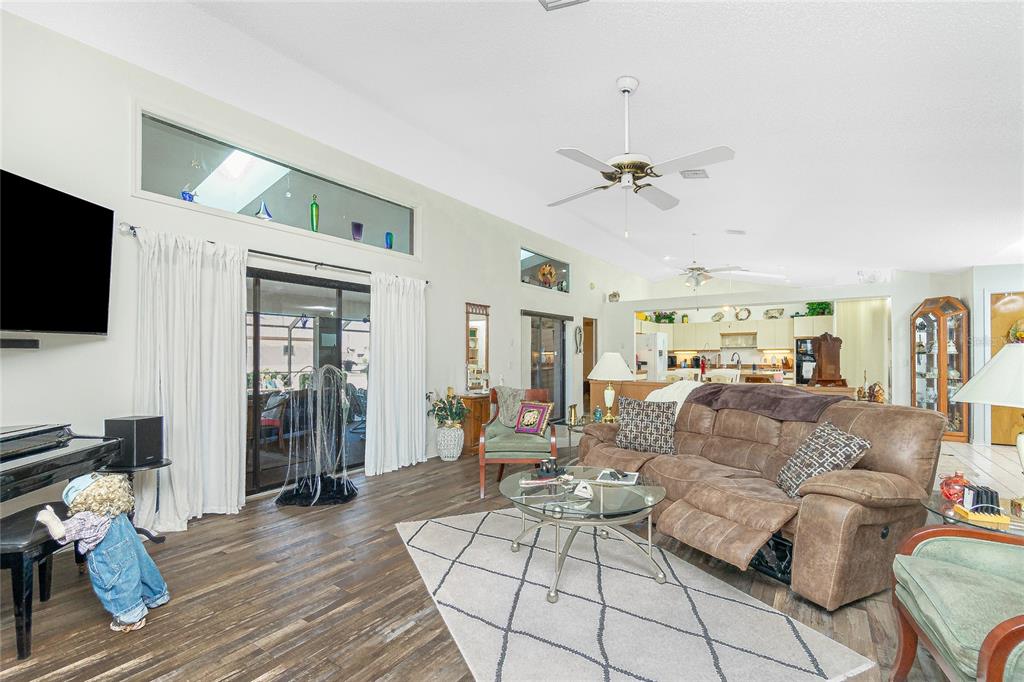204 Bunker Road Rotonda West, FL 33947 - Photo 11 of 49 a living room with furniture a flat screen tv and a ceiling fan