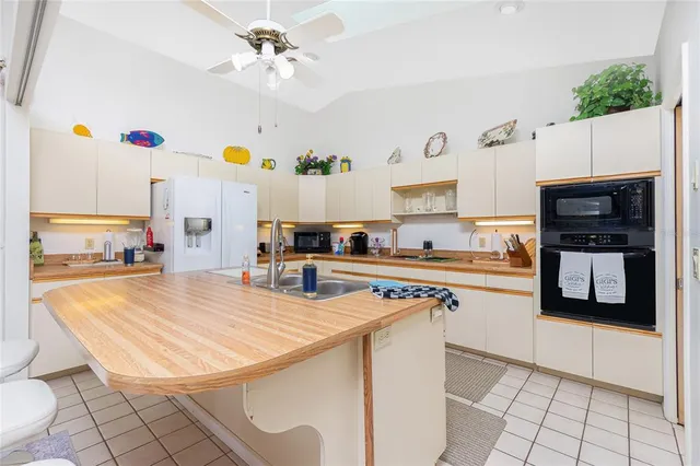 a kitchen with stainless steel appliances granite countertop a sink dishwasher stove top oven and cabinets