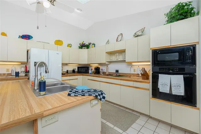 a kitchen with granite countertop a sink and a stove top oven