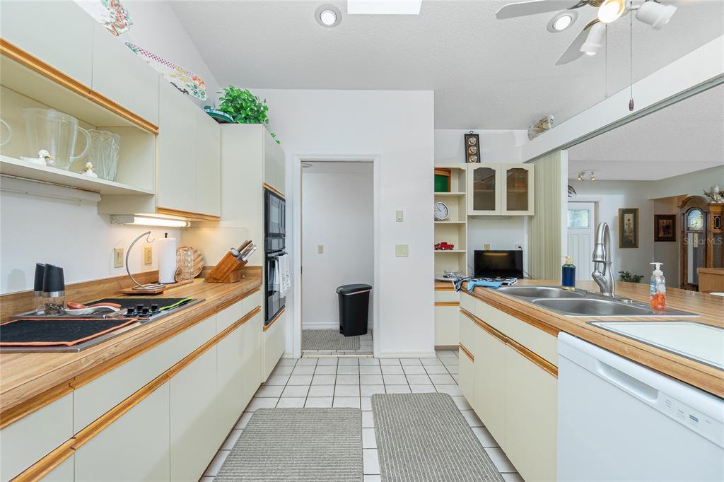 204 Bunker Road Rotonda West, FL 33947 - Photo 21 of 49 a kitchen with stainless steel appliances a stove a sink and a refrigerator