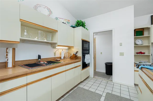 a kitchen with granite countertop a stove a sink and a refrigerator