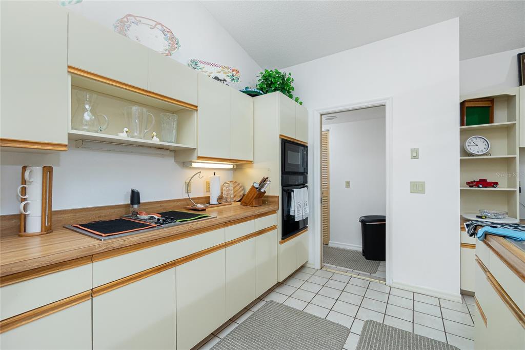 204 Bunker Road Rotonda West, FL 33947 - Photo 22 of 49 a kitchen with granite countertop a stove a sink and a refrigerator