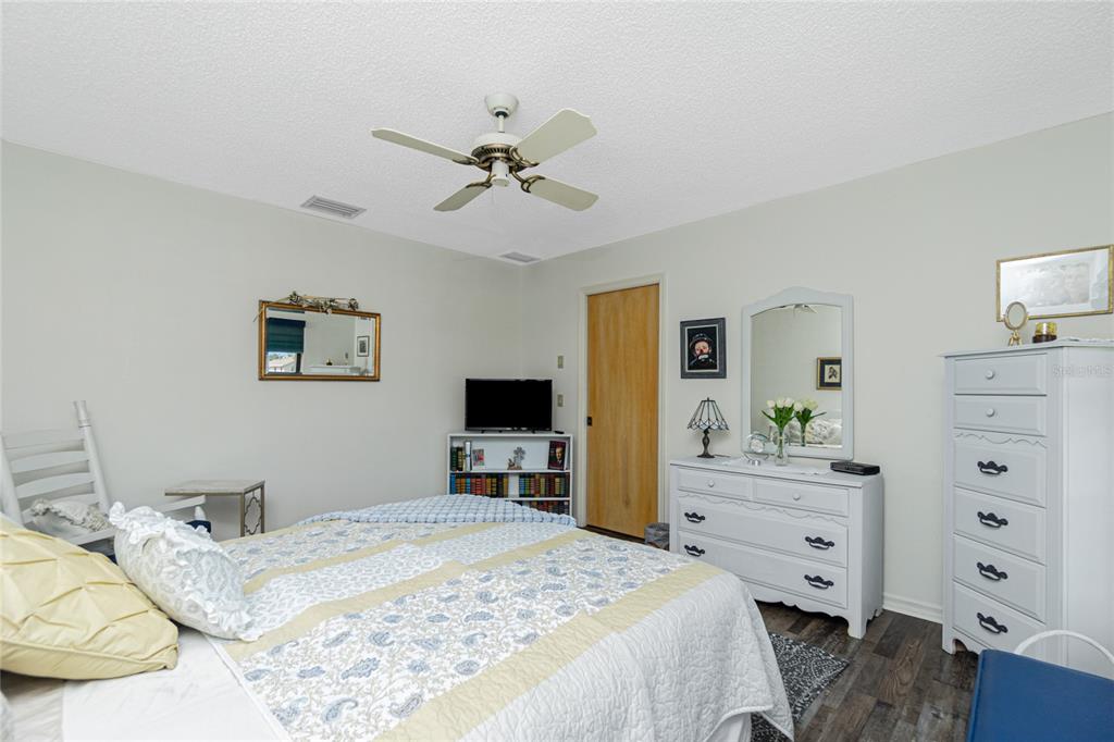 204 Bunker Road Rotonda West, FL 33947 - Photo 24 of 49 a bedroom with a bed and a flat screen tv