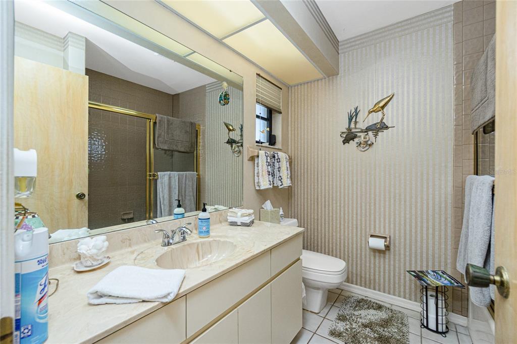 204 Bunker Road Rotonda West, FL 33947 - Photo 25 of 49 a bathroom with a granite countertop sink a toilet and a mirror