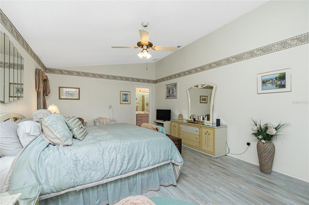 204 Bunker Road Rotonda West, FL 33947 - Photo 28 of 49 a bedroom with a bed and wooden floor