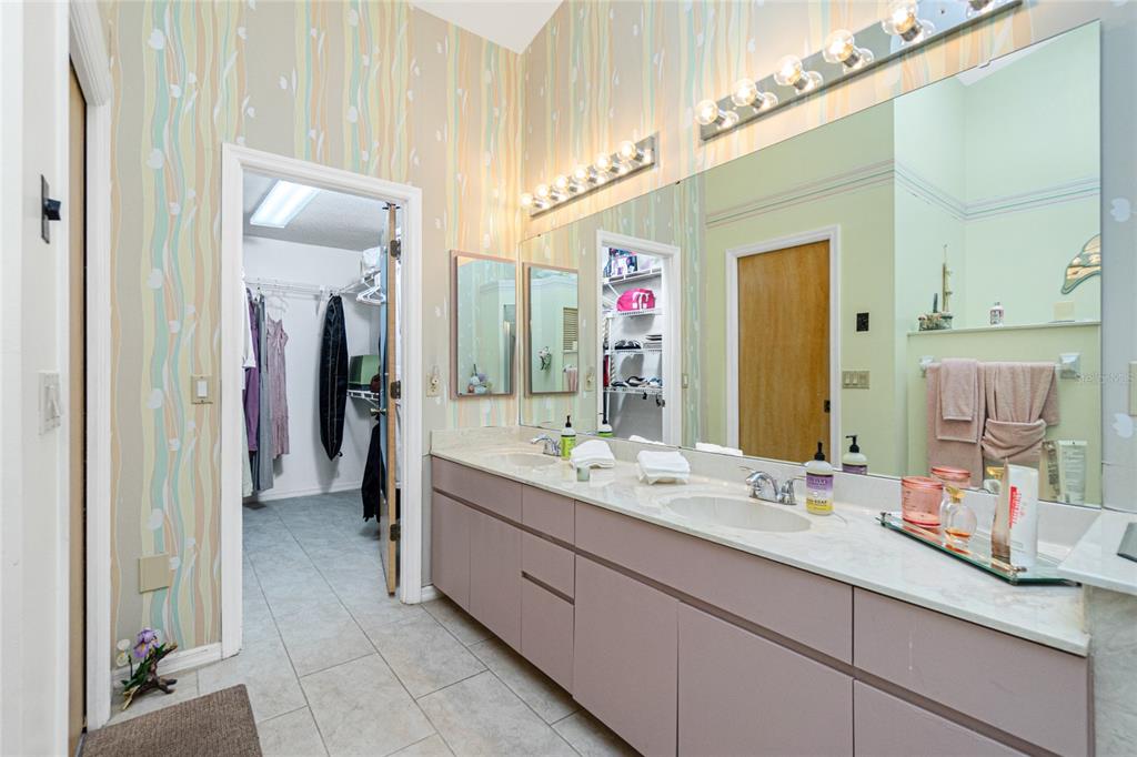 204 Bunker Road Rotonda West, FL 33947 - Photo 32 of 49 a bathroom with a double vanity sink and a mirror