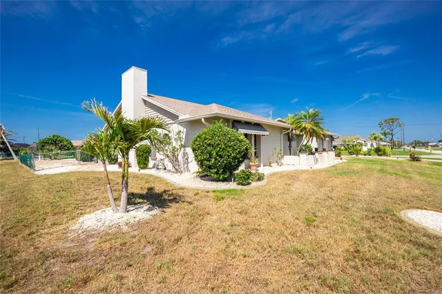 a view of a house with pool and yard