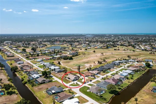 an aerial view of a house with a ocean view