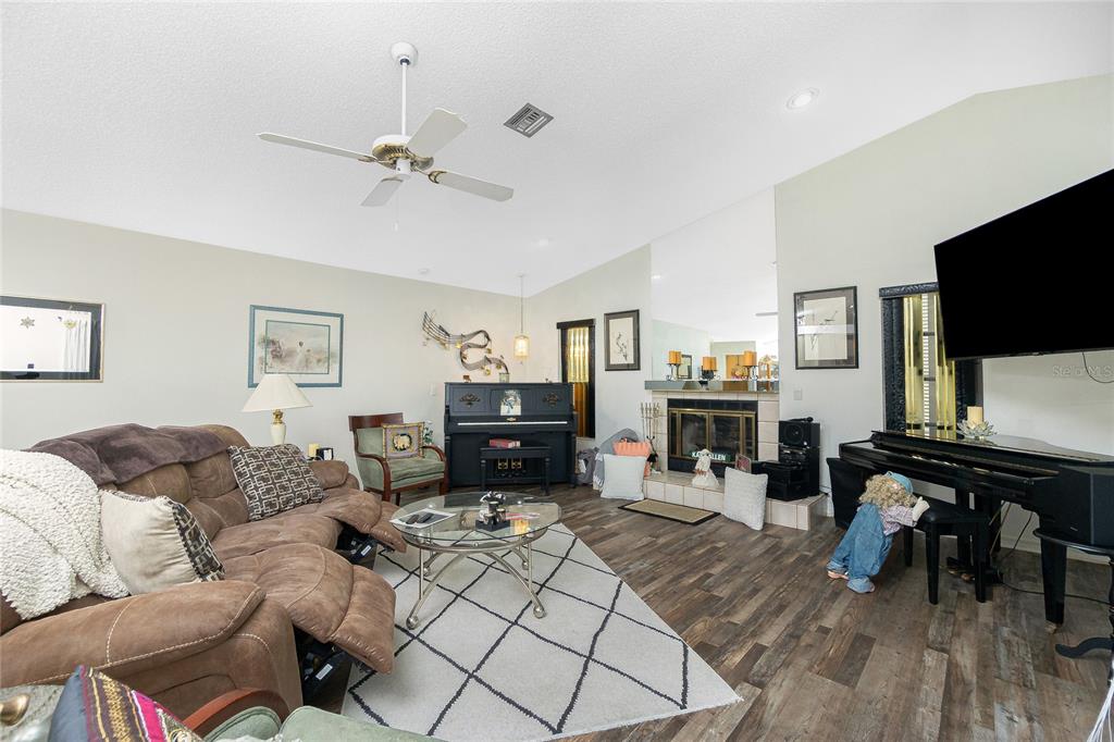 204 Bunker Road Rotonda West, FL 33947 - Photo 10 of 49 a living room with furniture and a flat screen tv with wooden floor