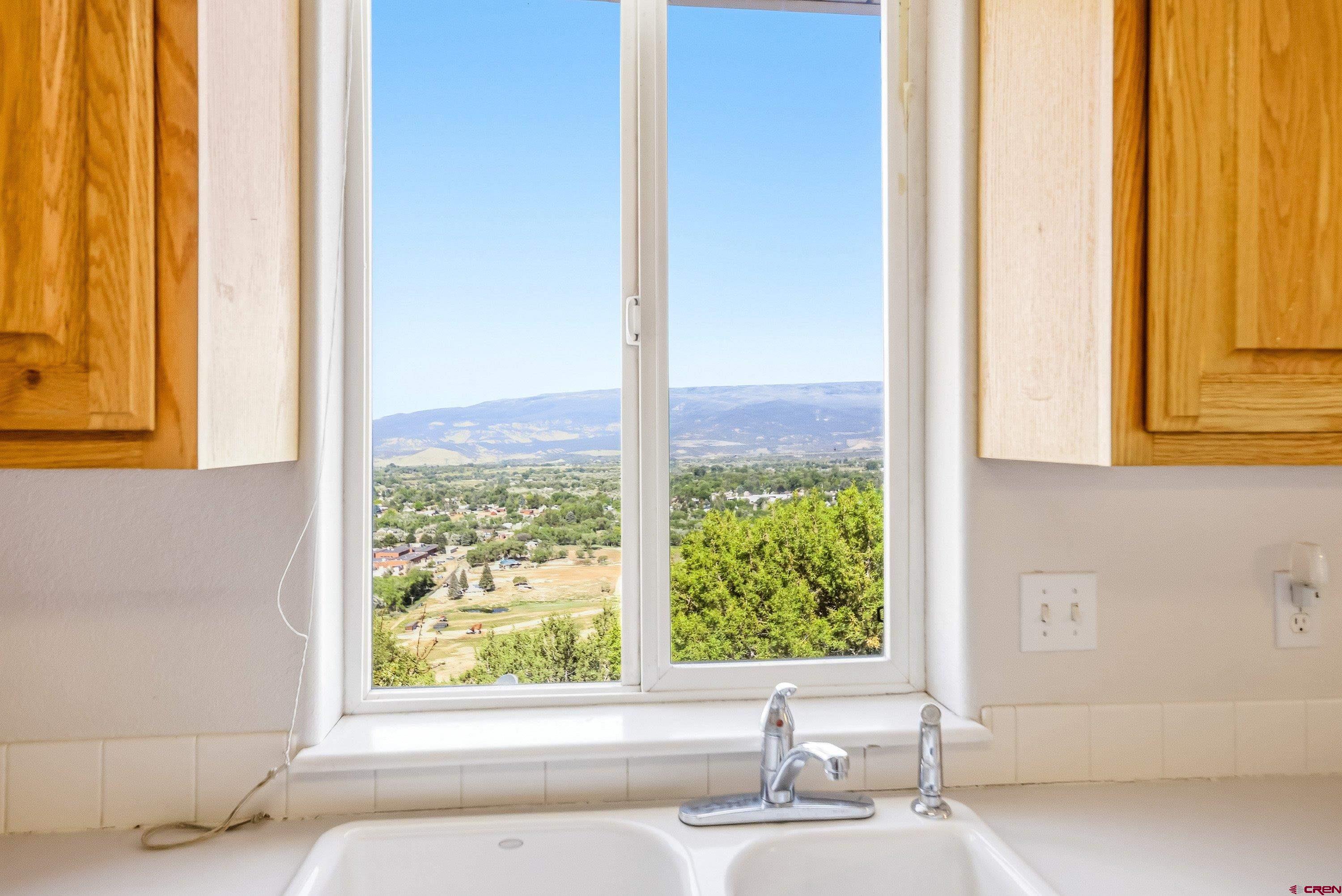 24239 Valley View Circle Cedaredge, CO 81413 - Photo 5 of 18 a bathroom with a bathtub and next to a window