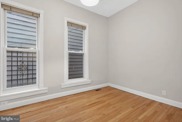 a kitchen with stainless steel appliances white cabinets and a refrigerator
