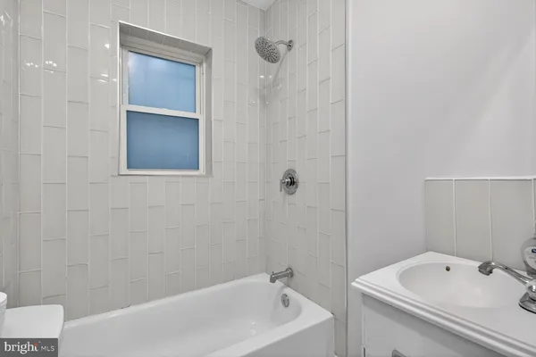 a bathroom with a tub and a sink