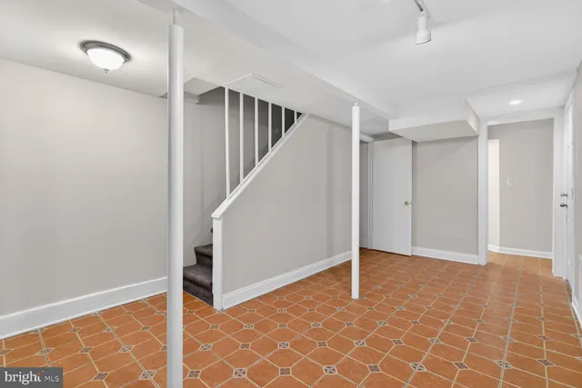 a bathroom with a granite countertop toilet and a shower