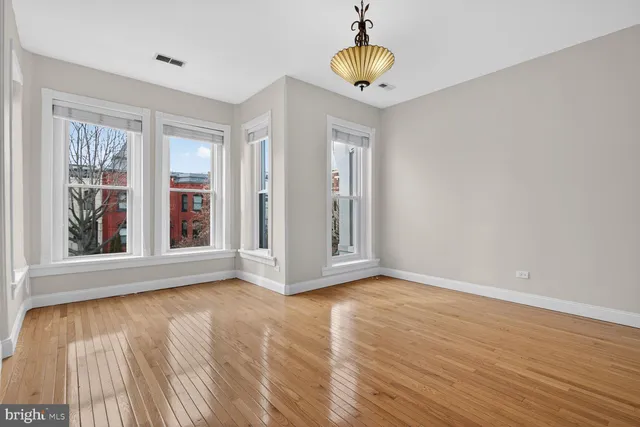 a white bath tub sitting next to a white sink and vanity