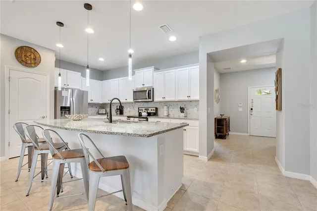 a kitchen with granite countertop a sink and a large window