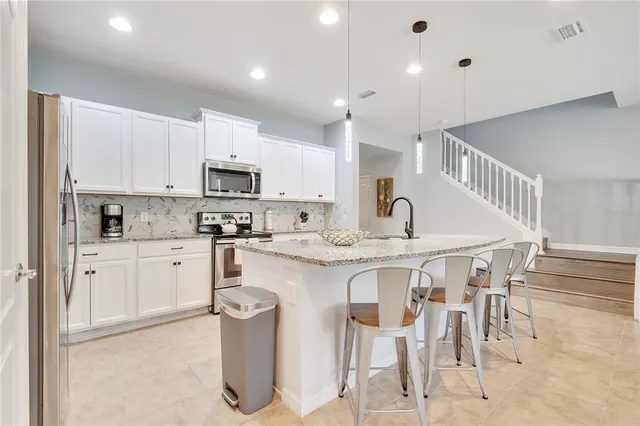 a view of a dining room with furniture and chandelier