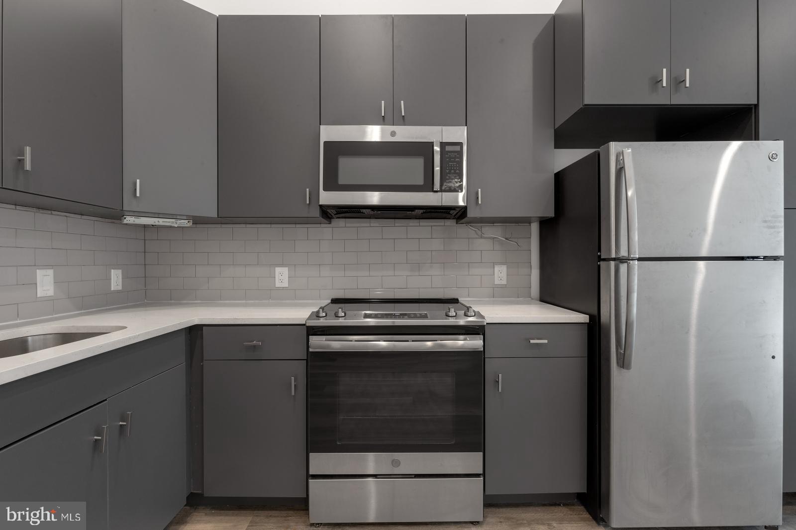 a kitchen with a stove and a microwave