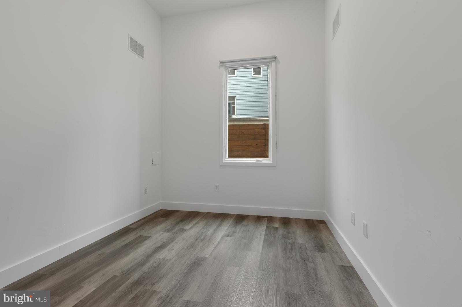 2559 Amber Street, Unit 101 Philadelphia, PA 19125 - Photo 12 of 35 a view of a small space with wooden floor and a window