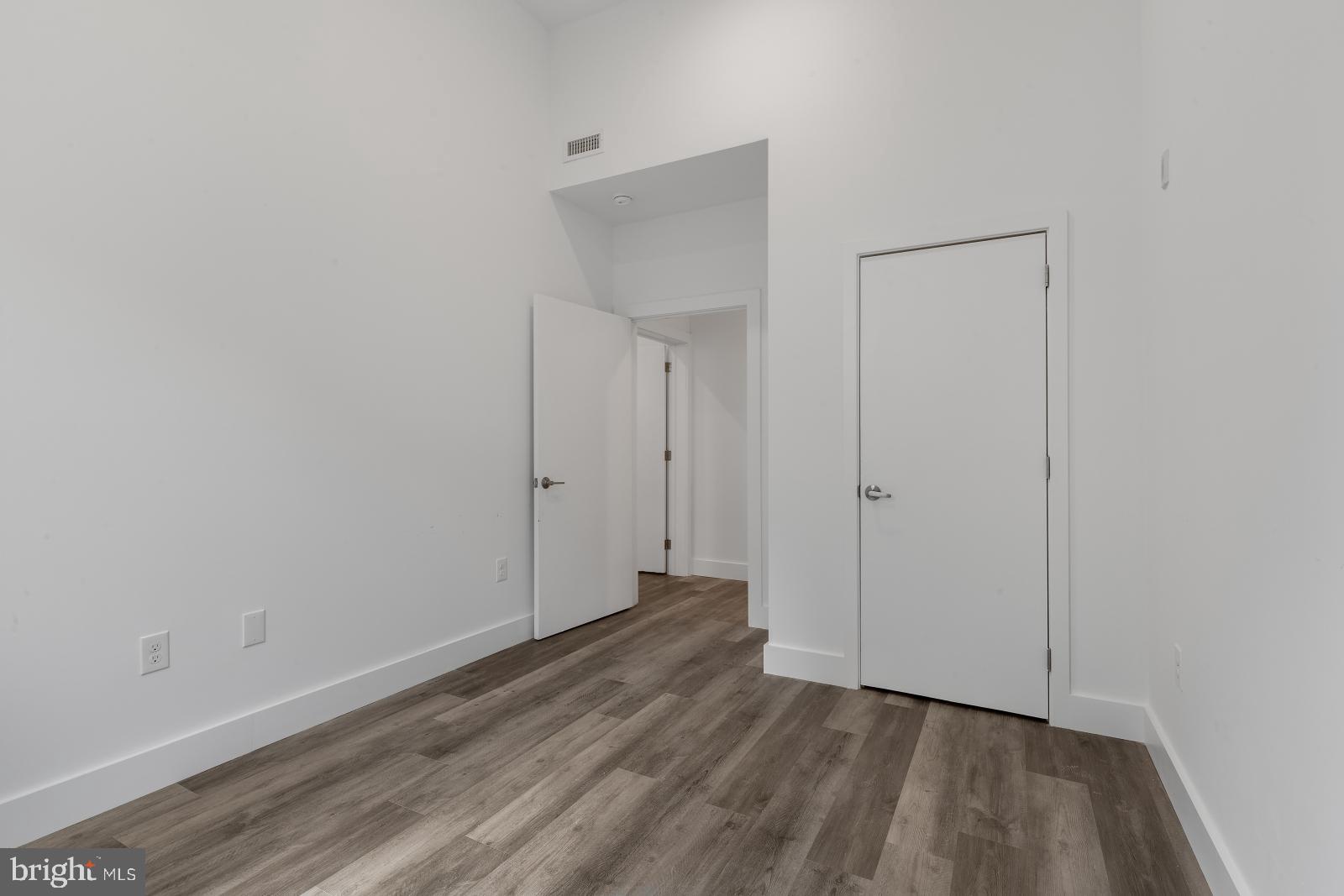 2559 Amber Street, Unit 101 Philadelphia, PA 19125 - Photo 14 of 35 a view of an empty room with wooden floor and closet
