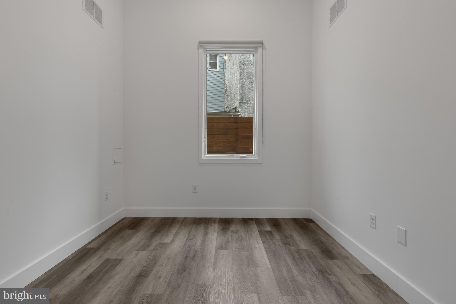 2559 Amber Street, Unit 101 Philadelphia, PA 19125 - Photo 15 of 35 a view of a small space with wooden floor and a window