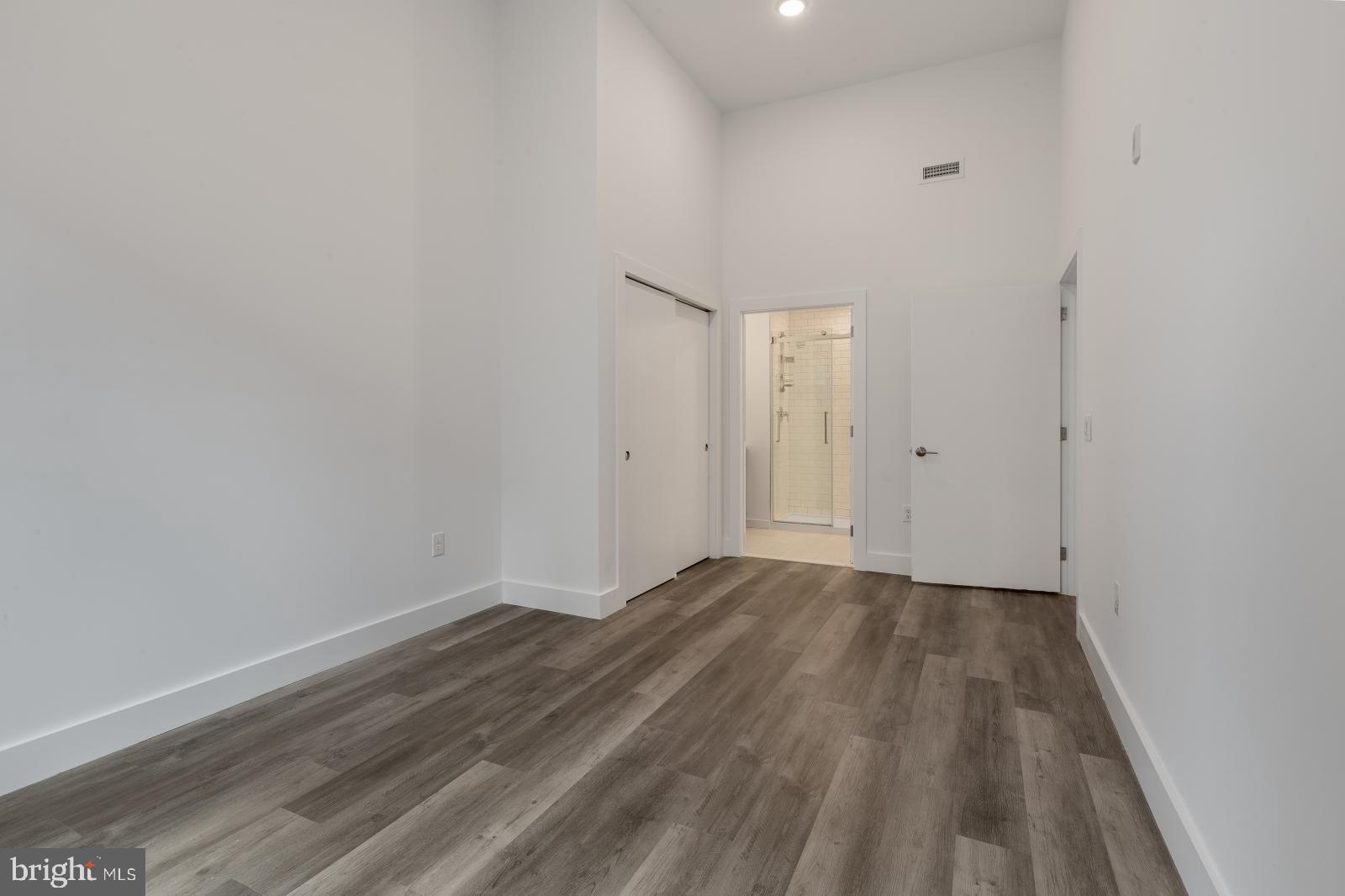 2559 Amber Street, Unit 101 Philadelphia, PA 19125 - Photo 21 of 35 a view of an empty room with wooden floor