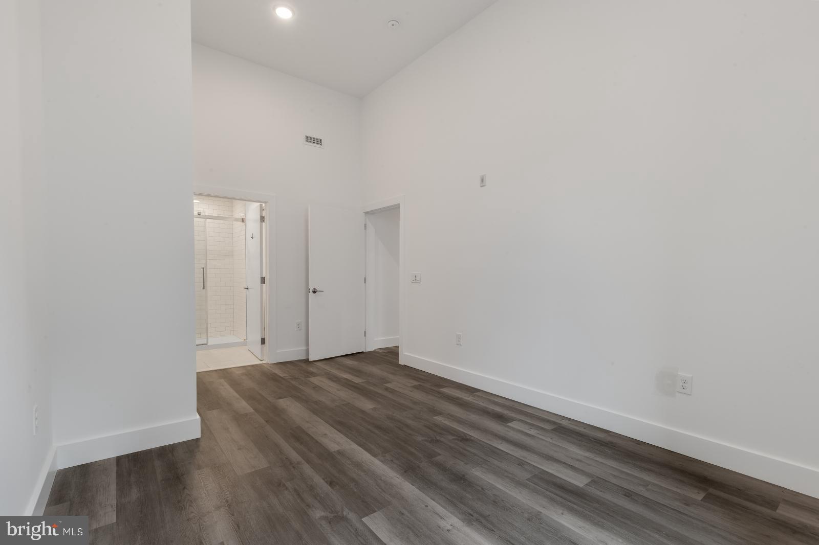 2559 Amber Street, Unit 101 Philadelphia, PA 19125 - Photo 22 of 35 a view of an empty room with wooden floor