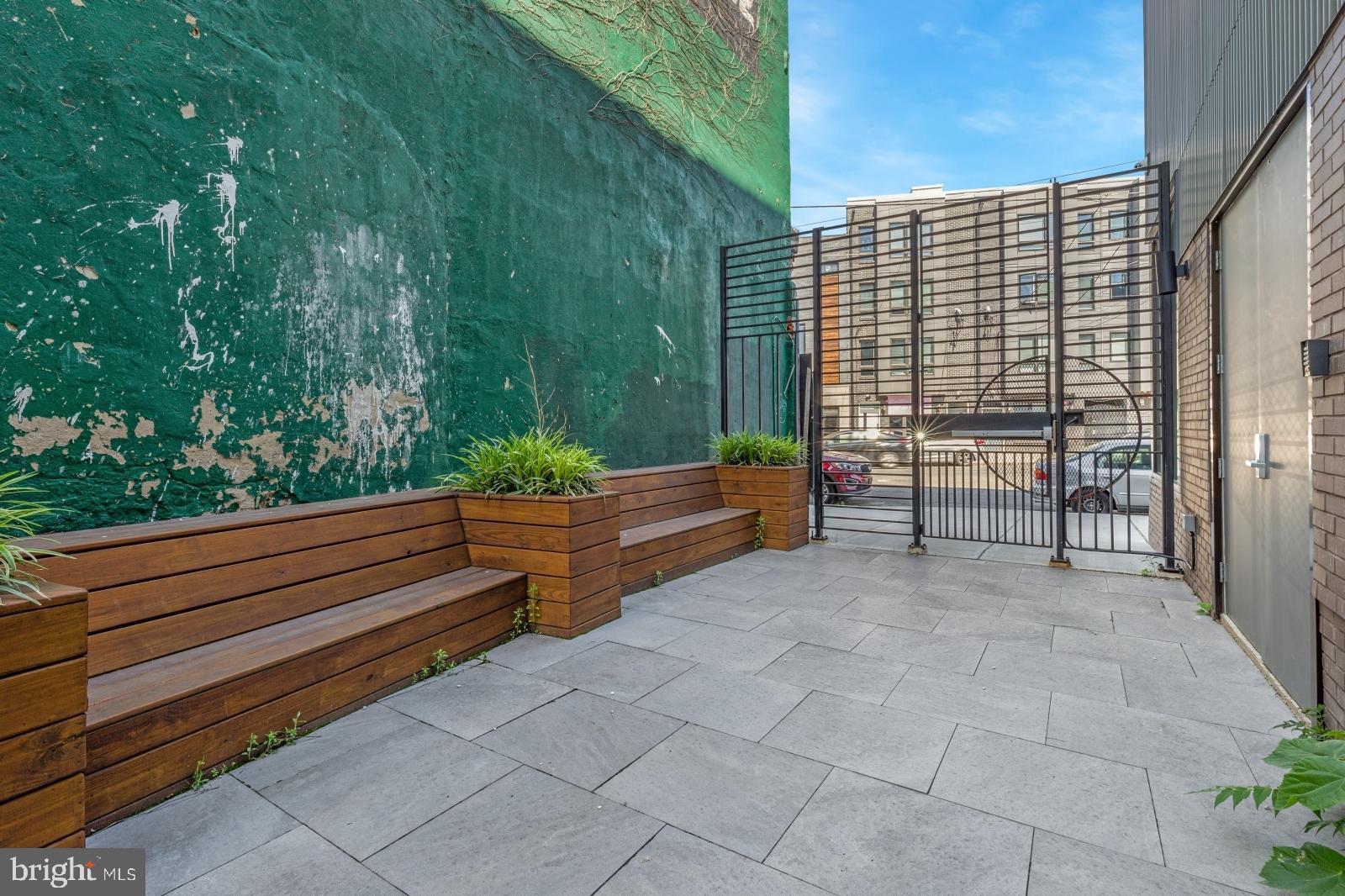2559 Amber Street, Unit 101 Philadelphia, PA 19125 - Photo 33 of 35 a backyard of a house with outdoor seating