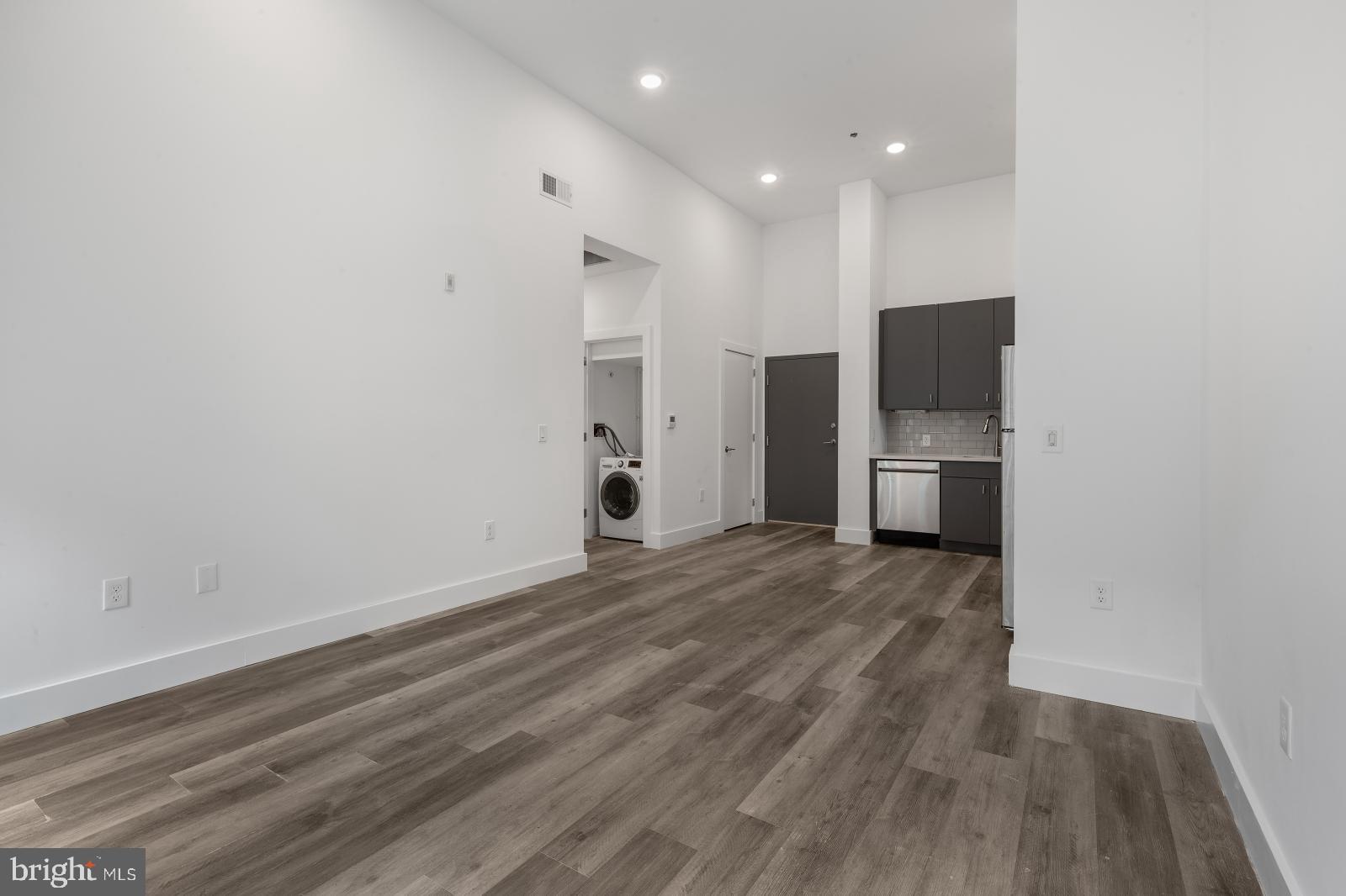 2559 Amber Street, Unit 101 Philadelphia, PA 19125 - Photo 6 of 35 a view of empty room with a fireplace and wooden floor
