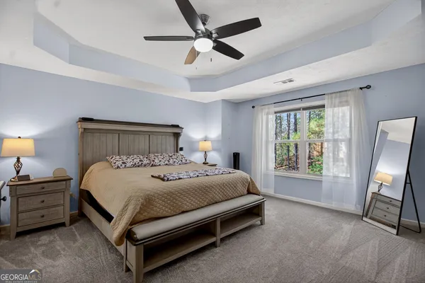 a bedroom with a bed next to a window